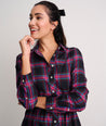 Model is wearing UNTUCKit Cassie dress in purple plaid. 