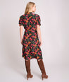 Model is wearing UNTUCKit Short Sleeve Fall Floral Midi Alix Dress in Black Orange Pink Floral Print.