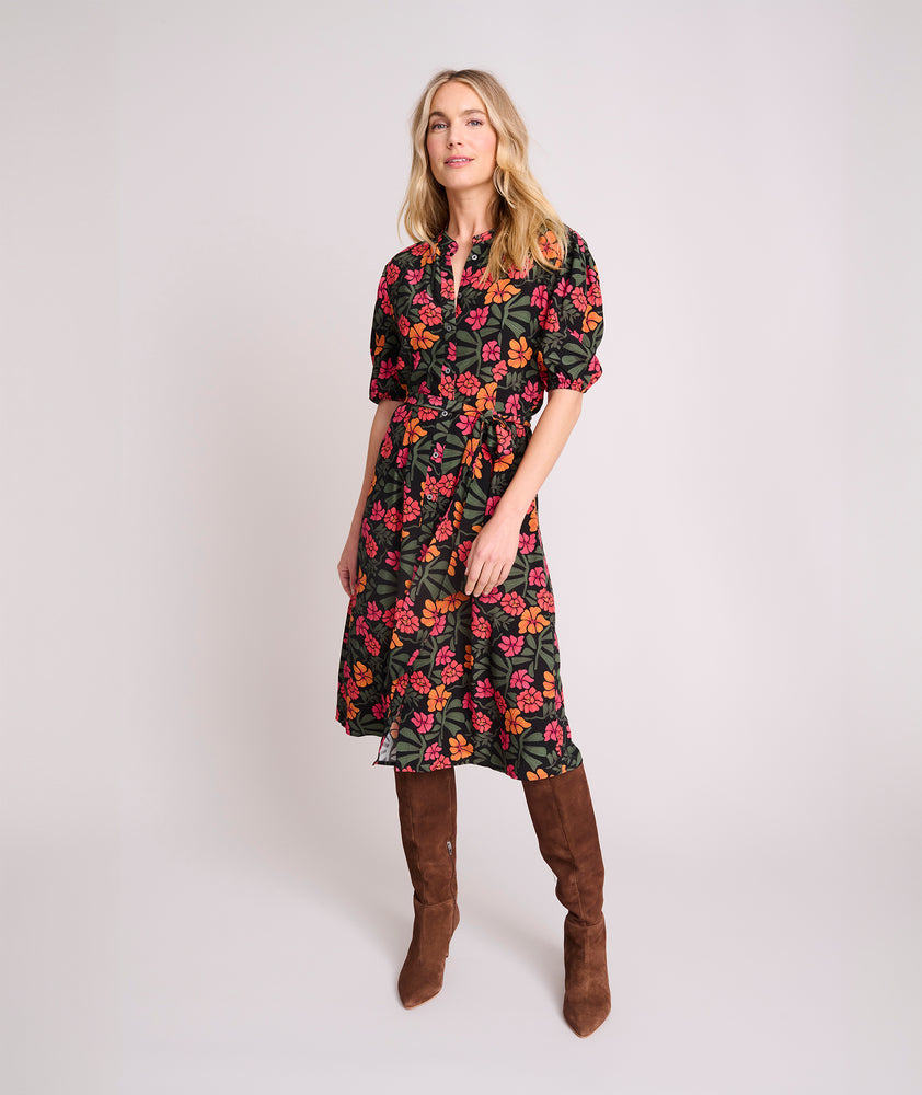 Model is wearing UNTUCKit Short Sleeve Fall Floral Midi Alix Dress in Black Orange Pink Floral Print.