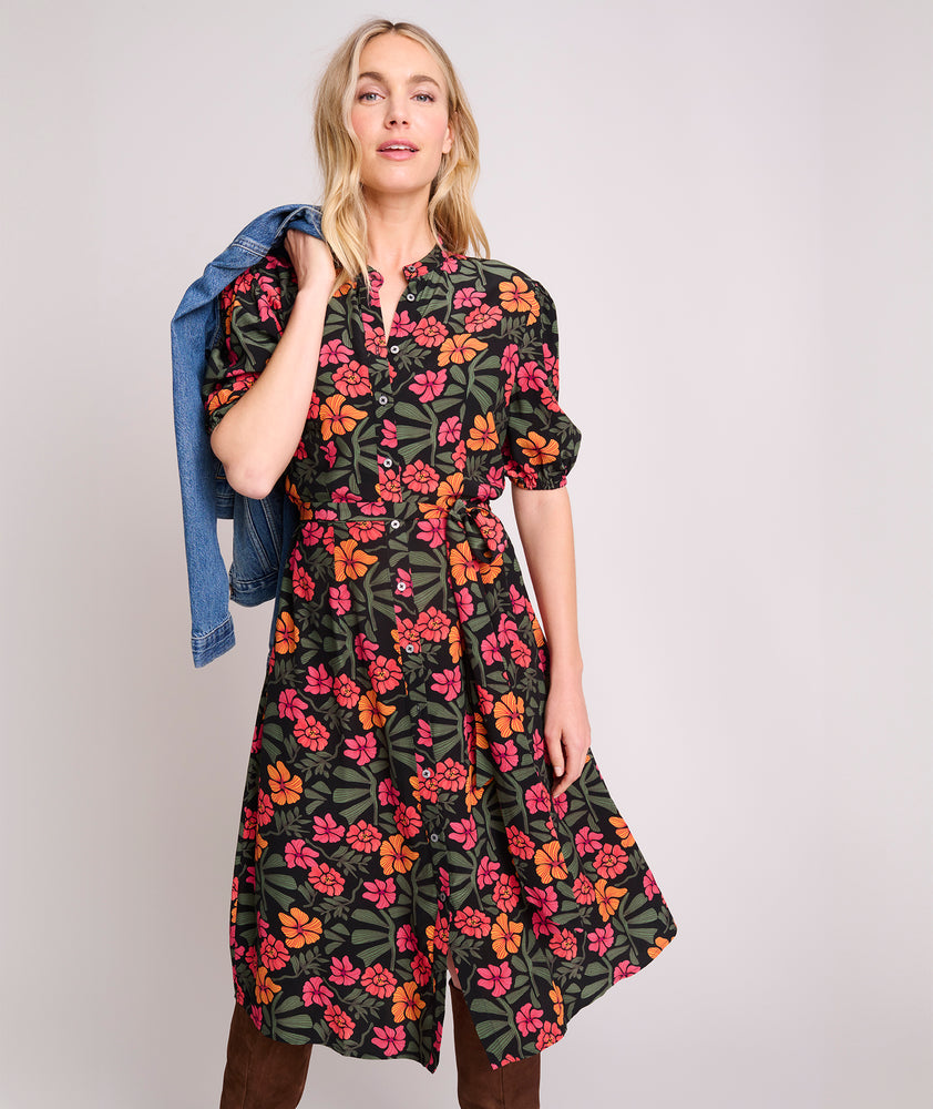 Model is wearing UNTUCKit Short Sleeve Fall Floral Midi Alix Dress in Black Orange Pink Floral Print.