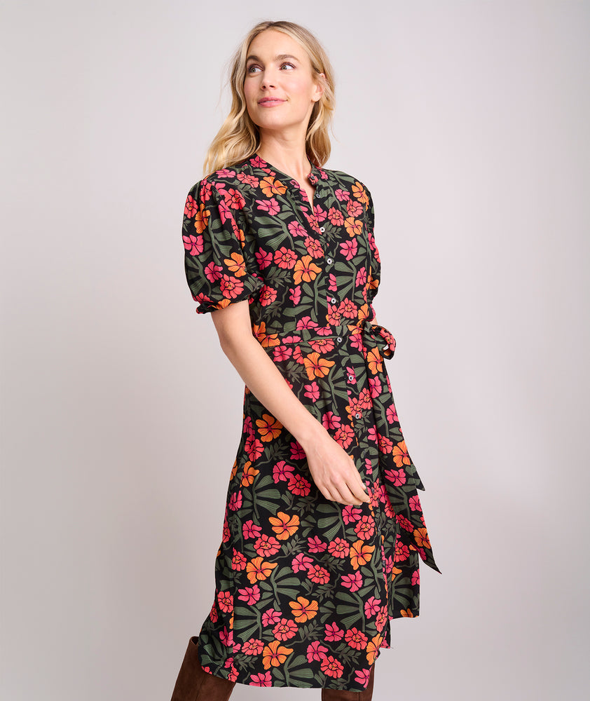 Model is wearing UNTUCKit Short Sleeve Fall Floral Midi Alix Dress in Black Orange Pink Floral Print.