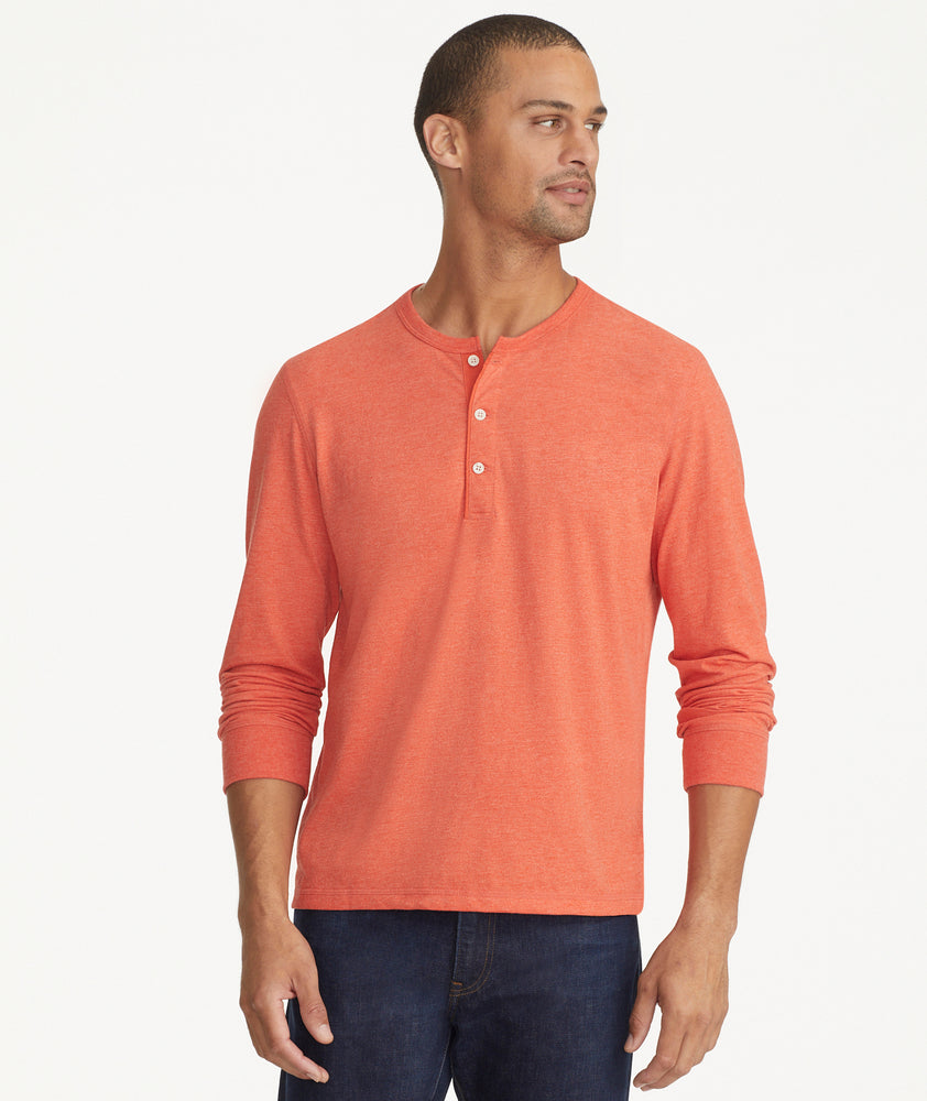 Model is wearing UNTUCKit ultra soft henley Albarino in Summer Fig.