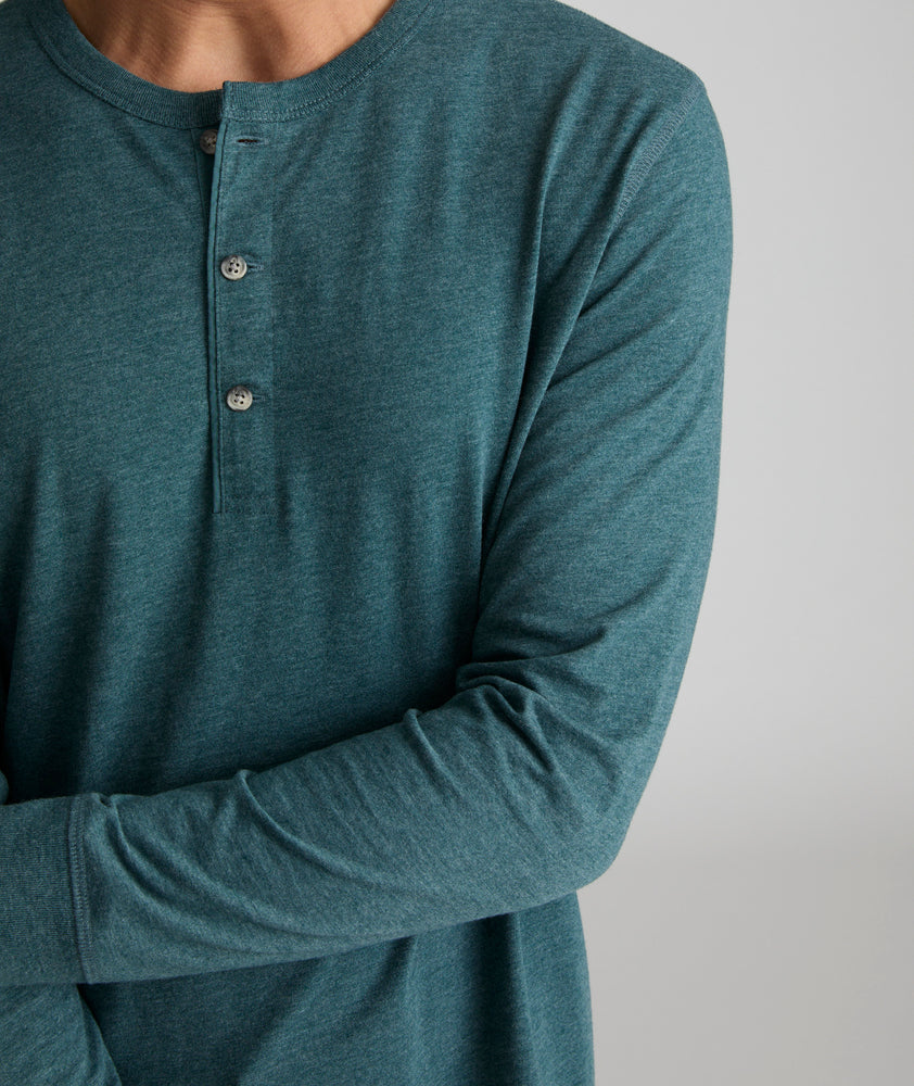 Model is wearing UNTUCKit Albarino Henley in Balsam. 