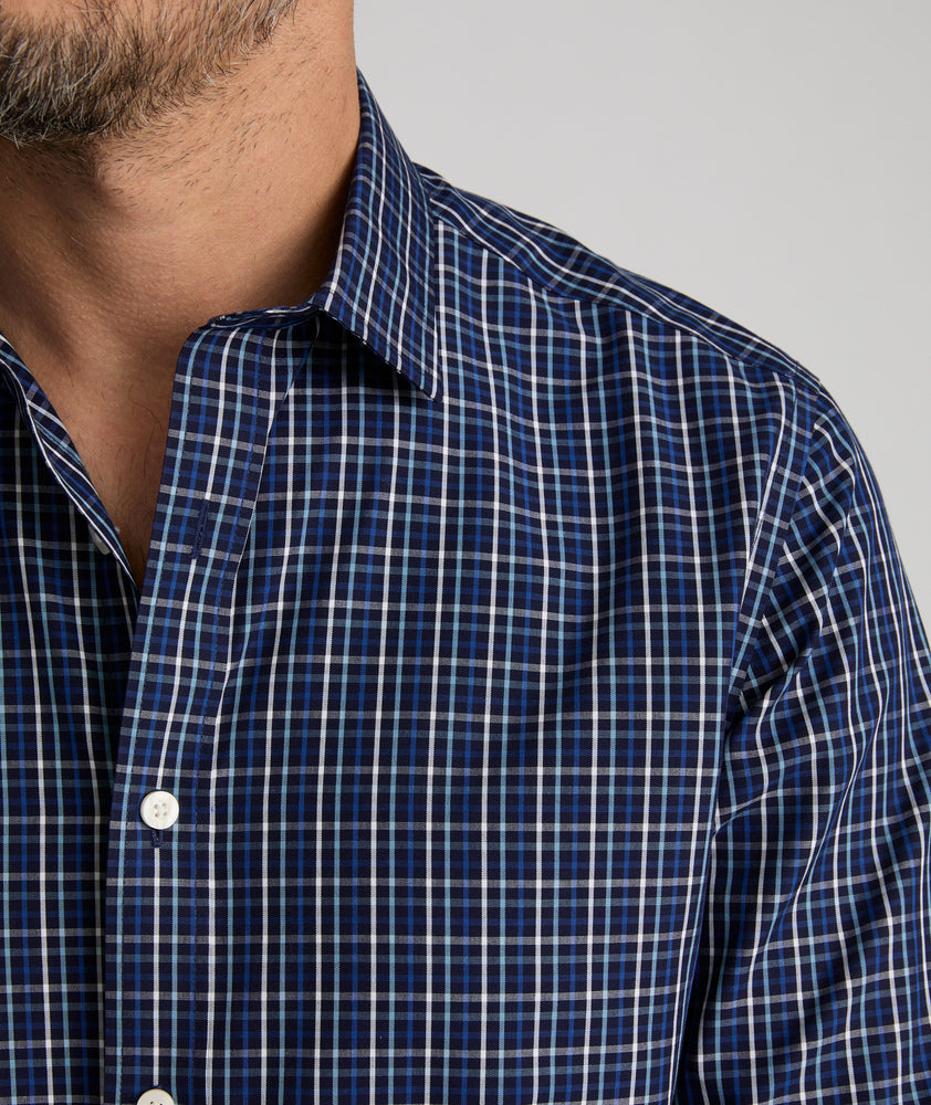 Model is wearing UNTUCKit Armstrong shirt in dark blue check.  