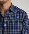 Model is wearing UNTUCKit Armstrong shirt in dark blue check.  