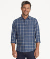 Model is wearing UNTUCKit Barton shirt in blue.