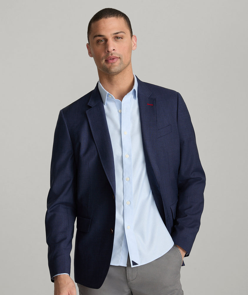 Model is wearing UNTUCKit Beasley sport coat in navy. 