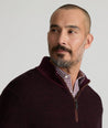 Model is wearing UNTUCKit Birdseye Merino Wool Quarter-Zip Sweater in Deep Purple.