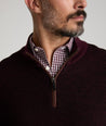 Model is wearing UNTUCKit Birdseye Merino Wool Quarter-Zip Sweater in Deep Purple.