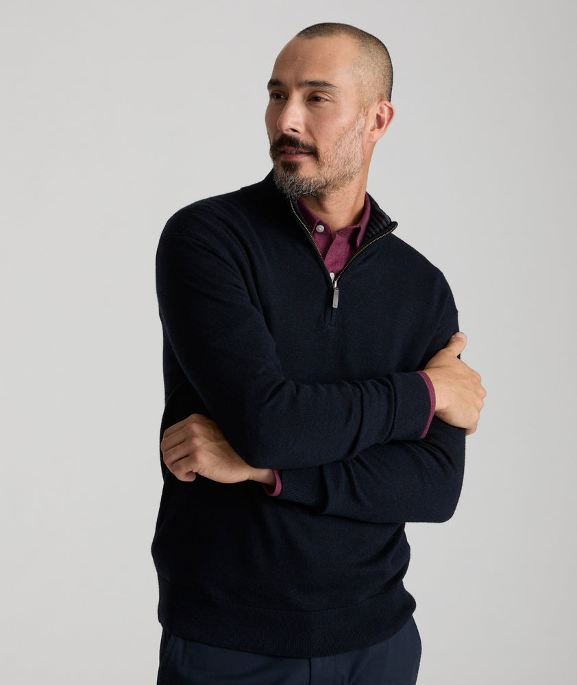 Model is weraring UNTUCKit Belguardo quarter zip in navy.