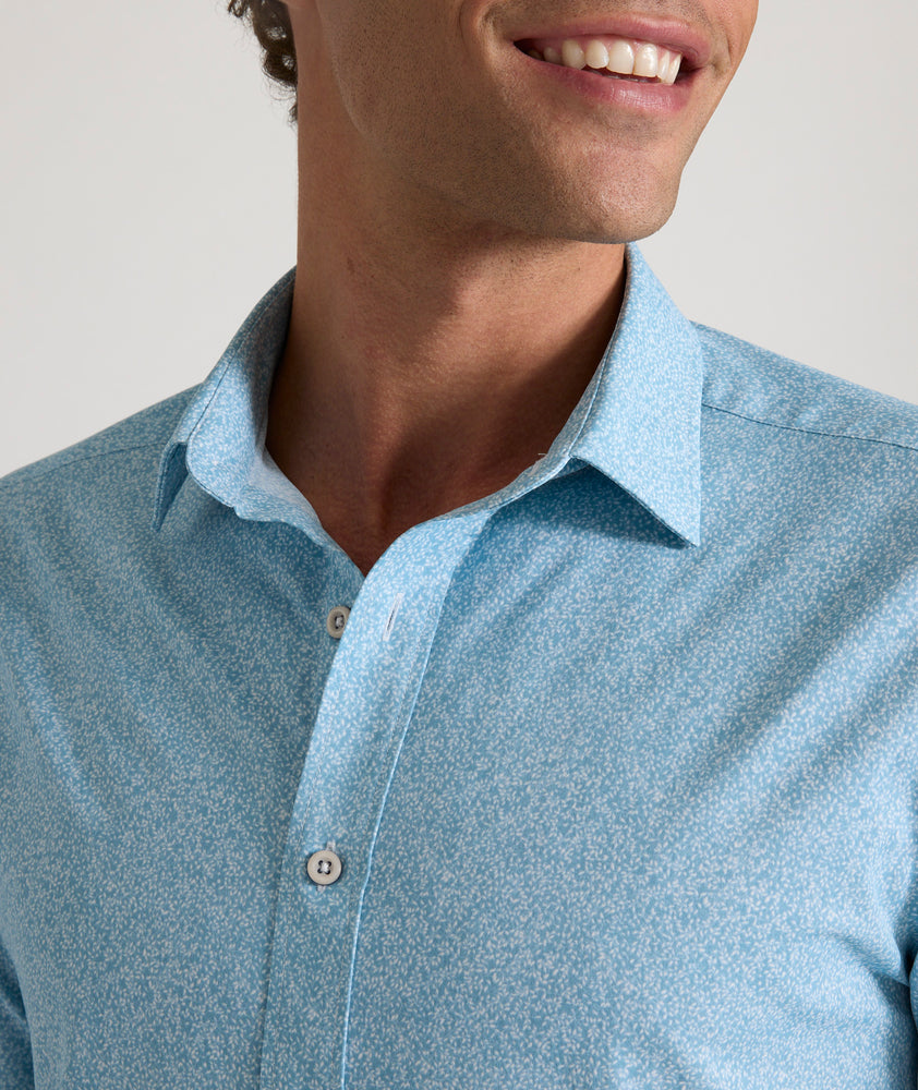 Model is wearing UNTUCKit Bell shirt in light blue floral print. 