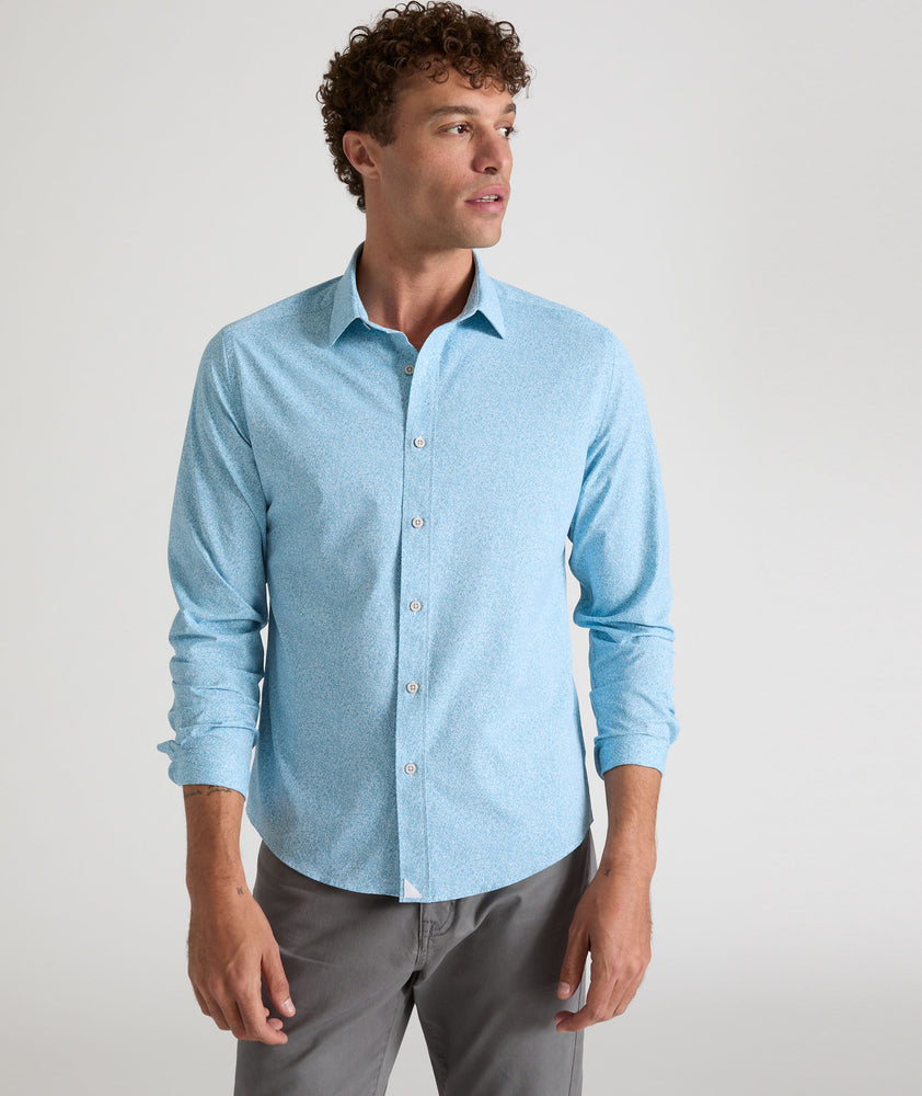 Model is wearing UNTUCKit Bell shirt in light blue floral print. 