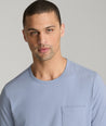 Model is wearing UNTUCKit berry pocket tee in stonewash.