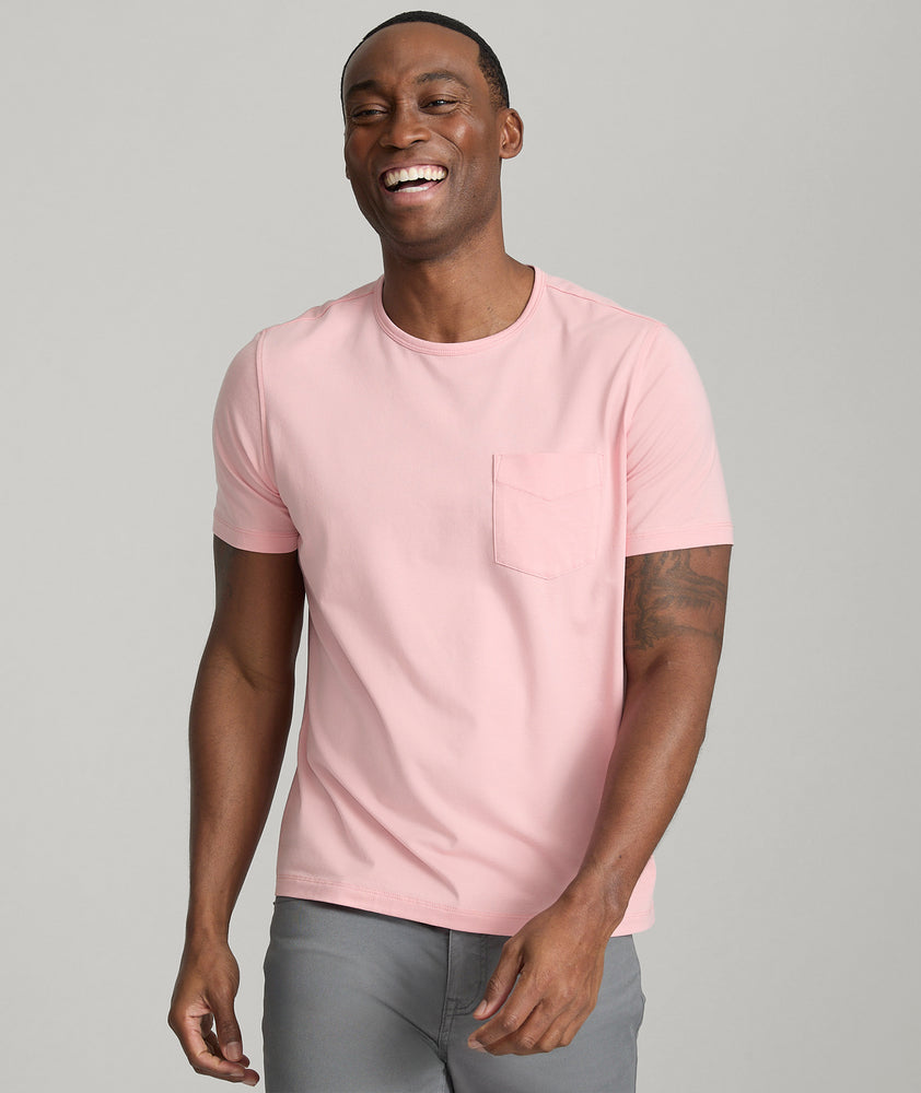 Model is wearing UNTUCKit berry pocket tee in quartz pink.