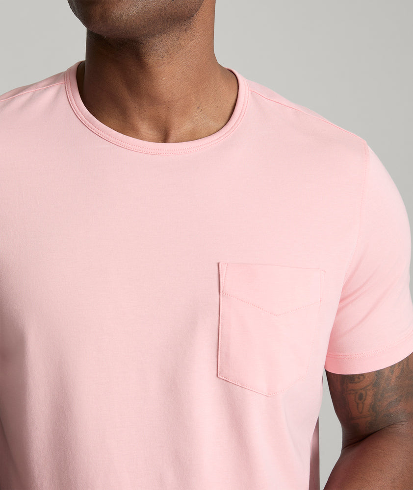 Model is wearing UNTUCKit berry pocket tee in quartz pink.