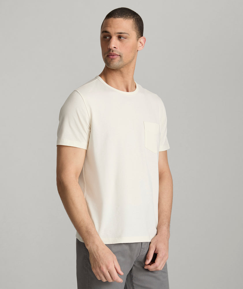 Model is wearing UNTUCKit berry pocket tee in vanilla ice.