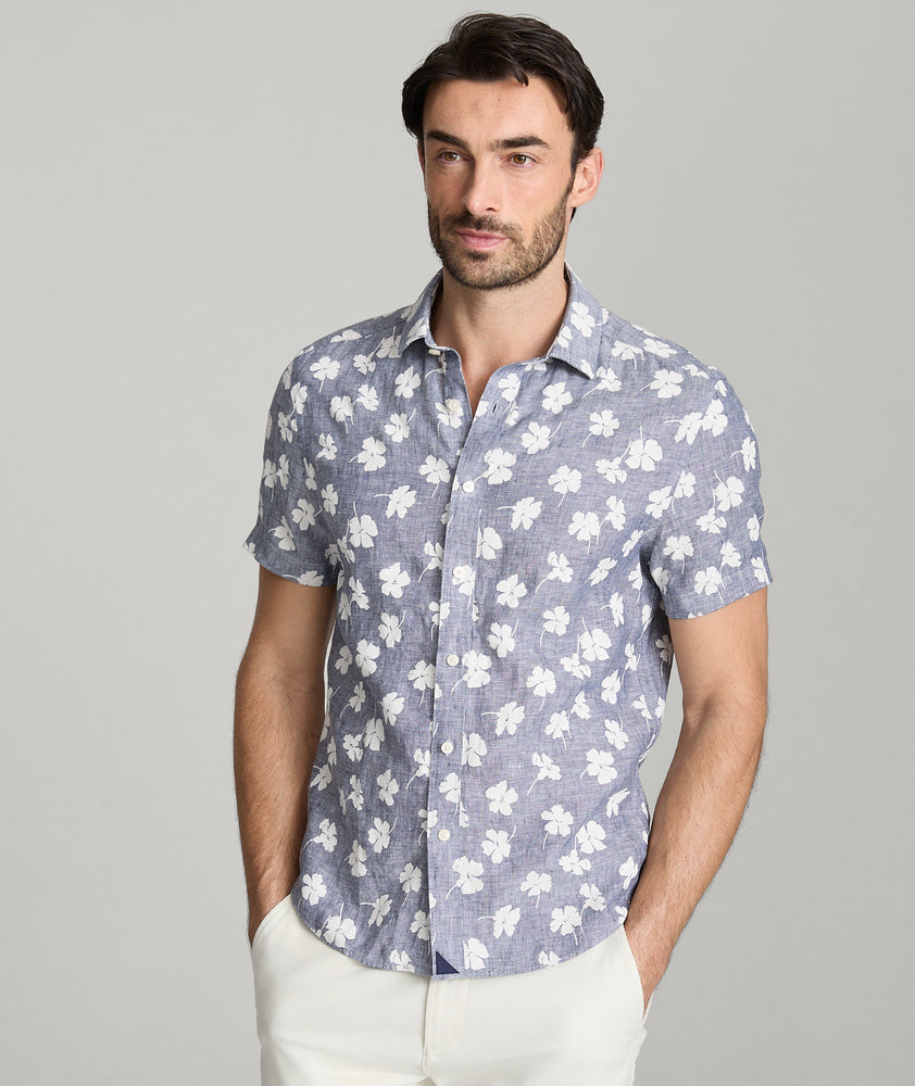 Model is wearing UNTUCKit bonner short sleeve shirt in Chambray Floral.