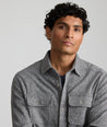 Model is wearing UNTUCKit Bonvino shirt in herringbone gray. 