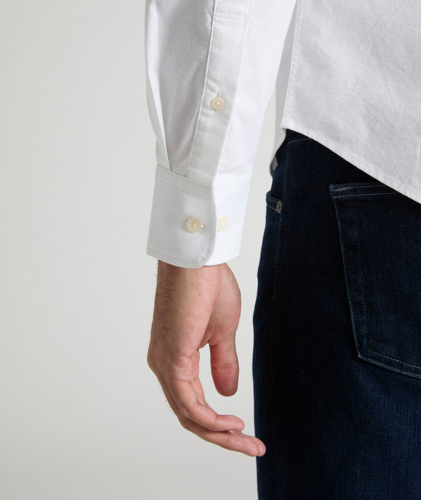 Model is wearing UNTUCKit Bridges shirt in white oxford stretch.