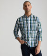 Model is wearing UNTUCKit Caldwell shirt in green large plaid.