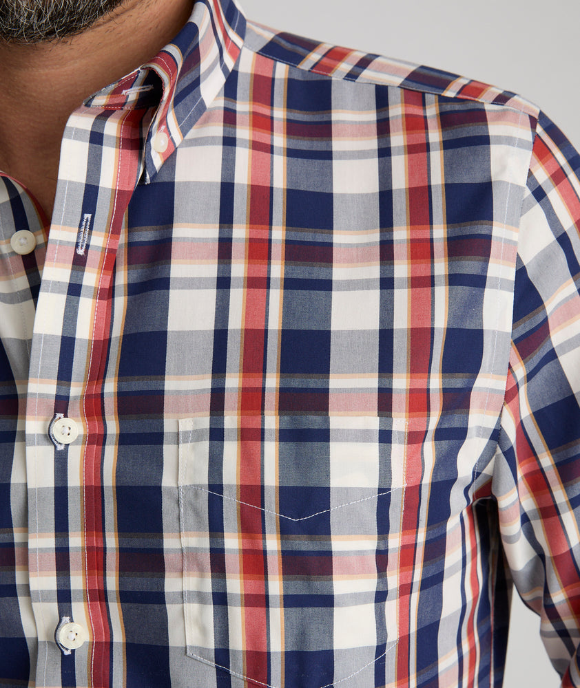 Model is wearing UNTUCKit Caldwell wrinkle-free plaid shirt in red. 