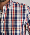 Model is wearing UNTUCKit Caldwell wrinkle-free plaid shirt in red. 