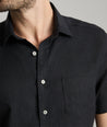 Model wearing an UNTUCKit Black Wrinkle-Resistant Linen Short Sleeve Cameron Shirt