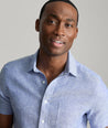 Model wearing an UNTUCKit Blue Wrinkle-Resistant Linen Short Sleeve Cameron Shirt.