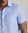 Model wearing an UNTUCKit Blue Wrinkle-Resistant Linen Short Sleeve Cameron Shirt.