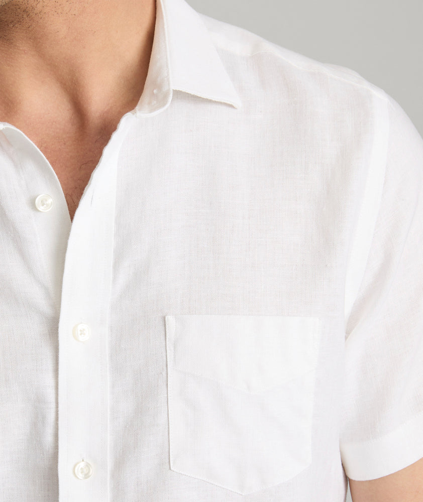 Model wearing an UNTUCKit Bright White Wrinkle-Resistant Linen Short-Sleeve Cameron Shirt.