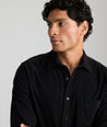 Model is wearing UNTUCKit Cord Shirt in black. 