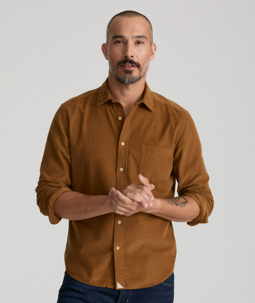 Model is wearing UNTUCKit Caprone Cord Shirt in golden brown.