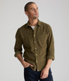 Model is wearing UNTUCKit Caprone Cord Shirt in dark olive.