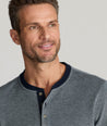 Model is wearing UNTUCKit Cascudo long sleeve pique henley in sky Captain.