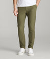 Model is wearing UNTUCKit Treveler Tech Pants in Ivy Green.