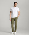 Model is wearing UNTUCKit Treveler Tech Pants in Ivy Green.