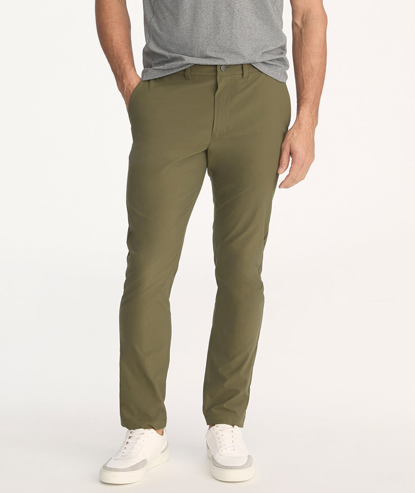 Model is wearing UNTUCKit Treveler Tech Pants in Ivy Green.