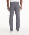 Model is wearing UNTUCKit Traveler Tech Pants in gray.