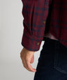 Model is wearing UNTUCKit Chaselo in bark maroon and black check over shirt.