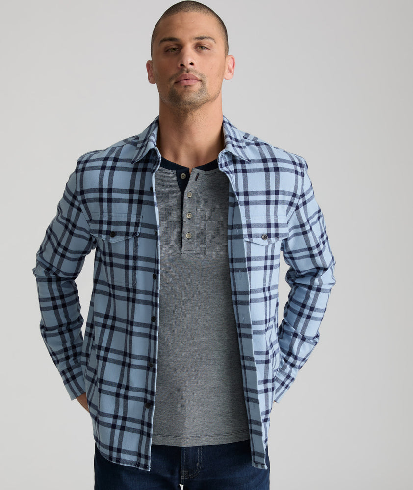 Model is wearing UNTUCKit Chaselo in light blue and navy check over shirt.