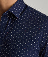 Model are wearing UNTUCKit Cilders short sleeve shirt in navy.