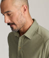 Model is wearing UNTUCKit Clavidor polo in olive.