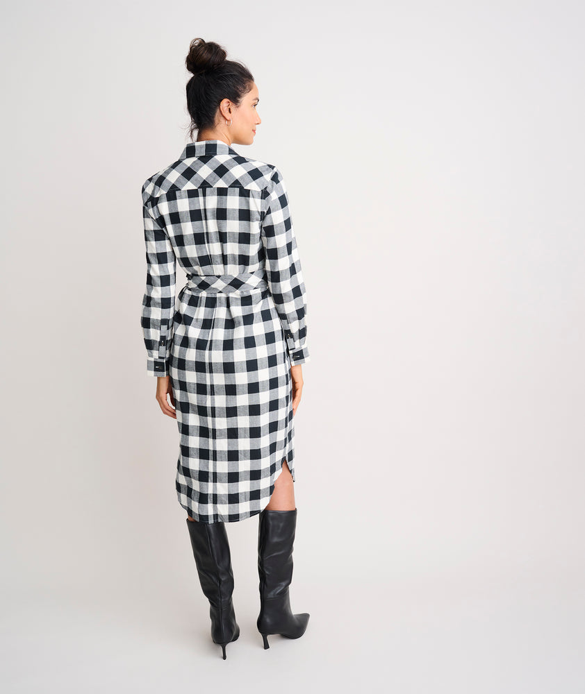 Model is wearing UNTUCKit Colby dress in black plaid.