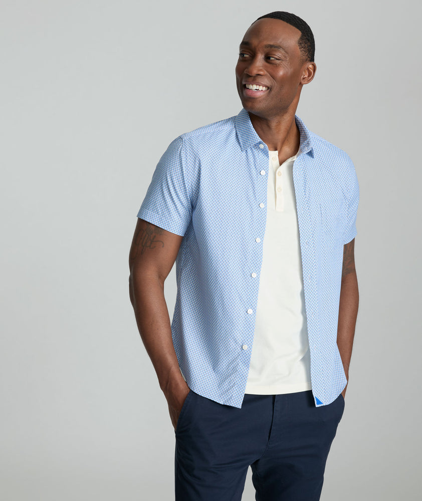 Model is wearing UNTUCKit Crofton performance shirt in blue. 