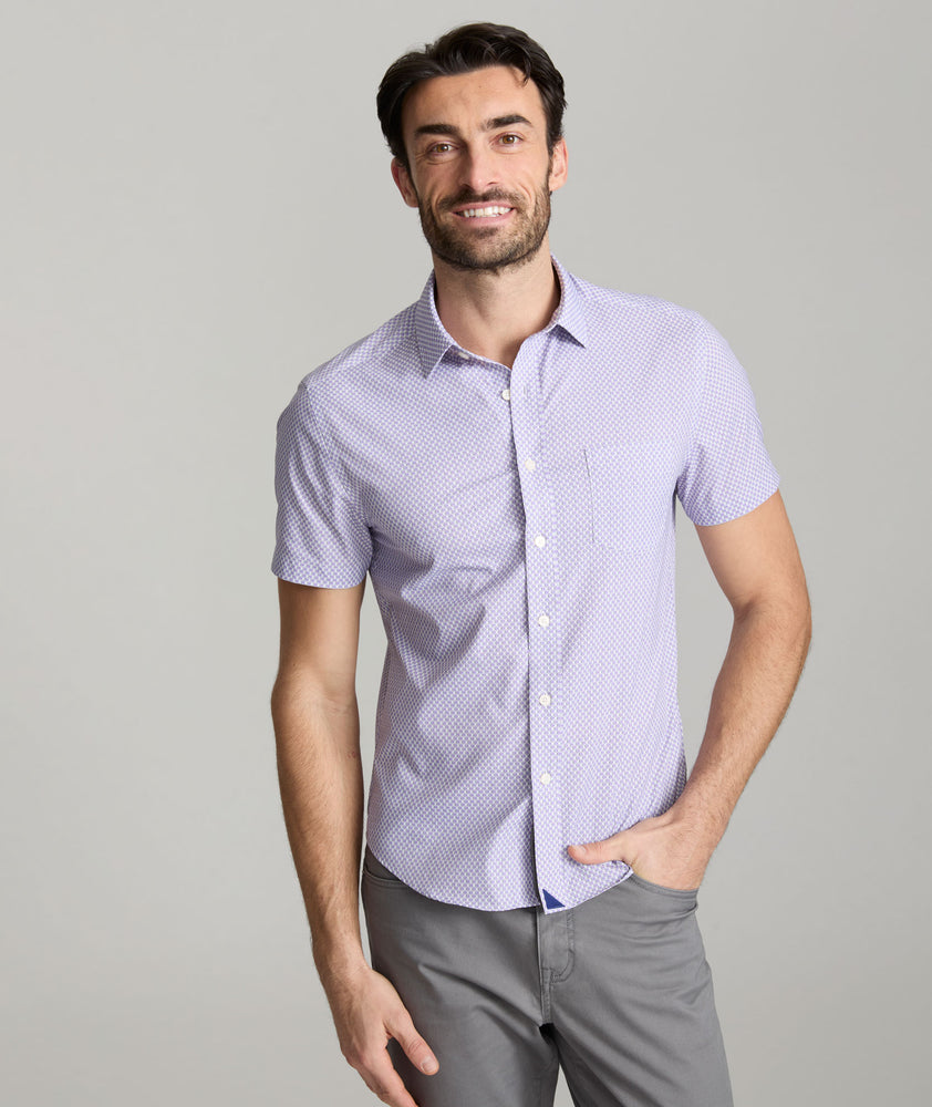 Model is wearing UNTUCKit Crofton shirt in performance purple print. 