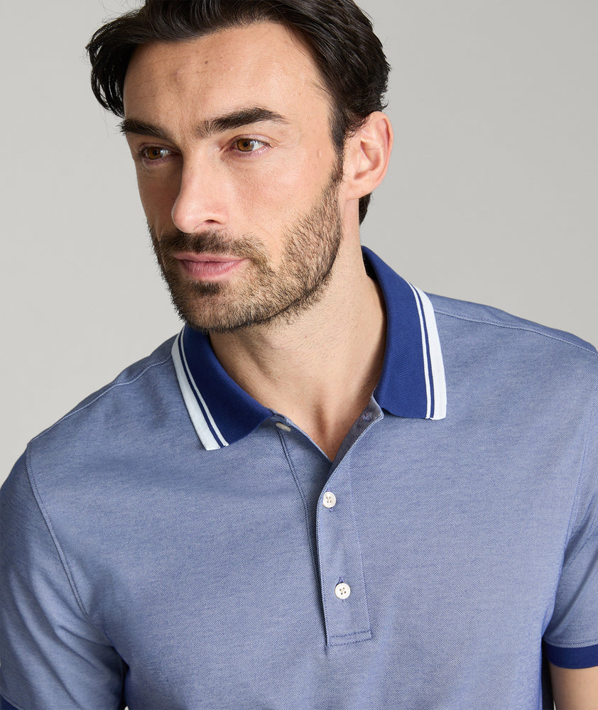 Model is wearing UNTUCKit Day Performance Polo in  Blue Depth.