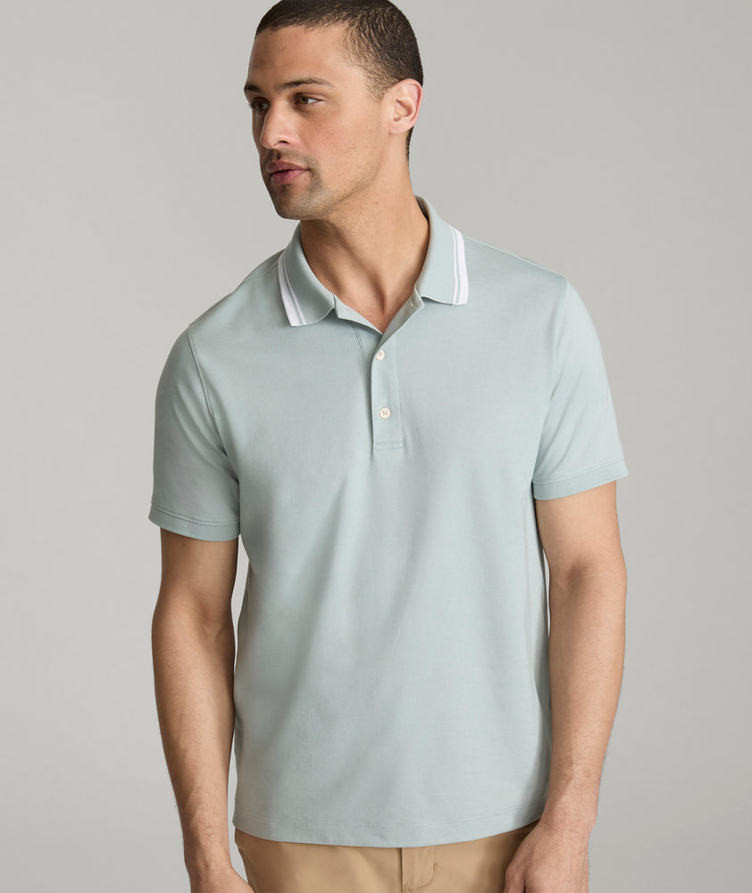 Model is wearing UNTUCKit Day Performance Polo in Green Milieu.