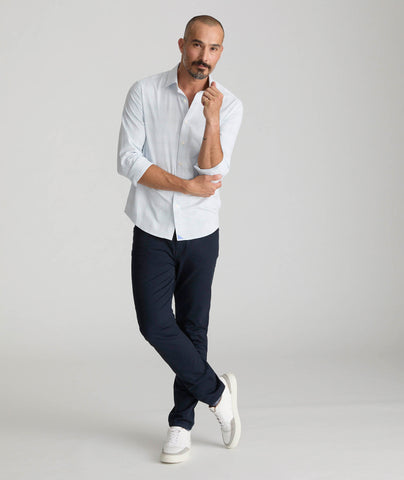 Model is wearing UNTUCKit 5-Pocket Chino Pants in navy.