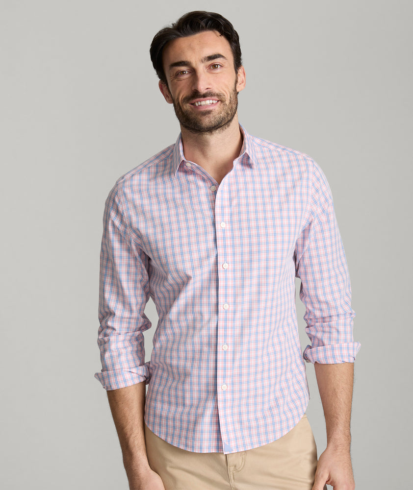 Model is wearing UNTUCKit Fairchild wrinkle free shirt in pink. 