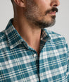 Model is wearing UNTUCKit Wrinkle-Free Performance Flannel Ferney Shirt in teal plaid.